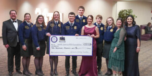 A group photo featuring Darin Spelhaug, Agricultural Education State Supervisor; Teagan Erbele; Mariah Lovro; Bailey Urlacher; Dawson Malkowski; Joe Lindberg; Laiken DeMorrett, Executive Director of the North Dakota FFA Foundation; Grant Anderson; Anna Palmer; Breanna Mueller, State Assistant Supervisor; and Nikki Fideldy-Doll, Agricultural Education State Supervisor, holding a ceremonial check for $200,000 from the Governor’s Heritage Foundation at Governor Kelly Armstrong’s Inaugural Ball. The donation supports North Dakota FFA’s programs statewide.
