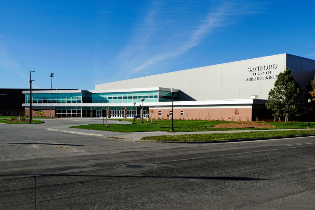 Exterior view of the Sanford Health Athletic Complex (SHAC) at North Dakota State University, a modern sports and event facility.