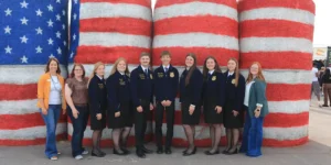 2026 ND FFA state officer team during the Industry Tour in front of USA hay bales at the Red River Valley Fair