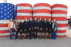 2026 ND FFA state officer team during the Industry Tour in front of USA hay bales at the Red River Valley Fair