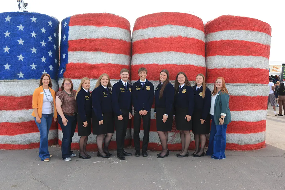 2026 ND FFA state officer team during the Industry Tour in front of USA hay bales at the Red River Valley Fair